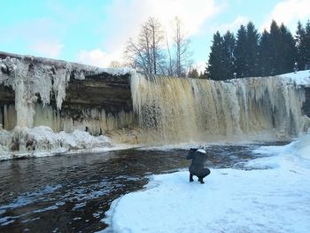 Scenic view of waterfall against sky