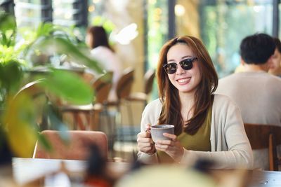 Portrait of young woman sitting in cafe