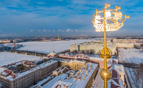 High angle view of illuminated buildings against cloudy sky