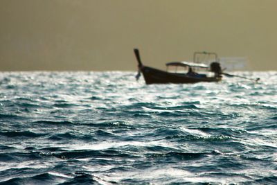 Man in sea against sky