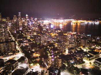 High angle view of illuminated buildings in city at night