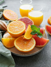 Glasses of juice and fresh citrus fruits