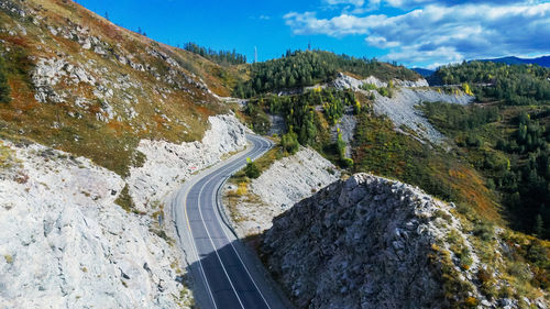 High angle view of road amidst rocks and mountains against sky