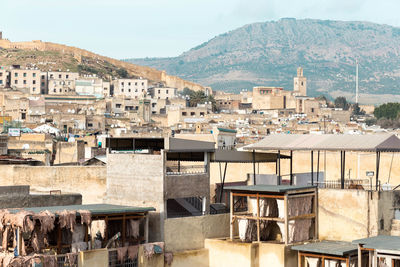 Houses in town against sky