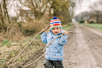 Full length of boy wearing hat while standing on land