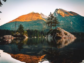 Scenic view of lake and mountains against clear sky