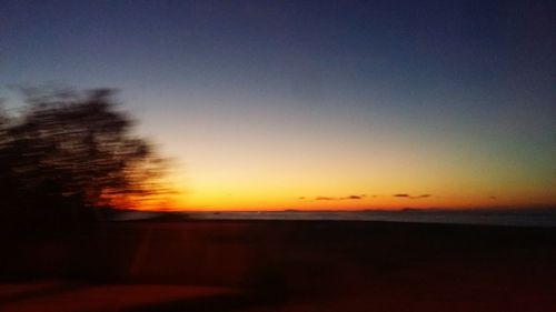 Scenic view of sea against clear sky during sunset