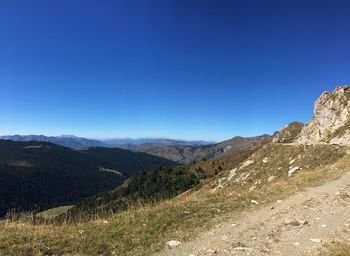 Scenic view of mountains against clear blue sky