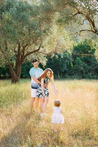 People on field by tree