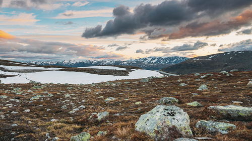 Scenic view of snowcapped mountains against sky during sunset