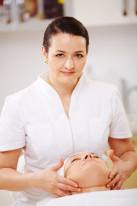 Close-up of woman getting beauty treatment from doctor