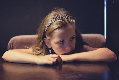 Close-up of girl sitting by table at home