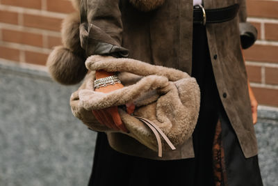 Midsection of woman wearing hat