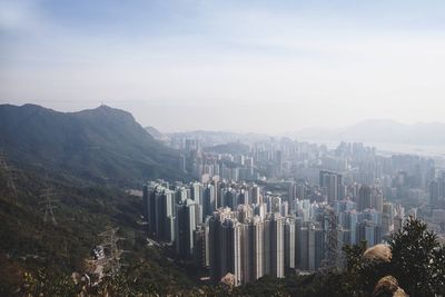 Aerial view of buildings in city against sky