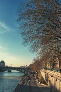 Bridge over river in city against sky