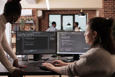 Rear view of woman working in office