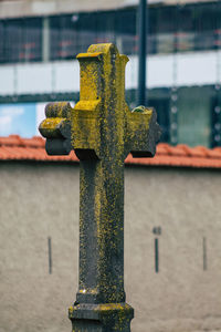 Close-up of cross on metal structure