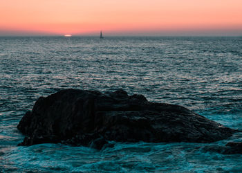 Scenic view of sea against sky at sunset