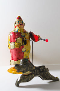 Close-up of figurine toy against white background