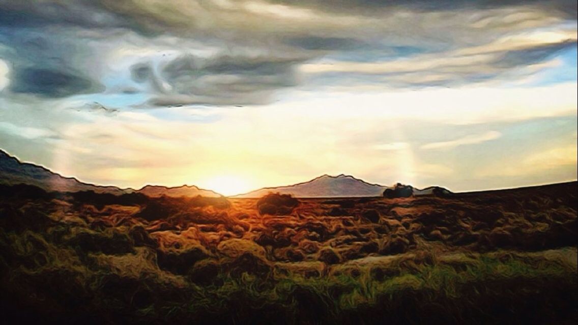 SCENIC VIEW OF MOUNTAINS AGAINST CLOUDY SKY AT SUNSET