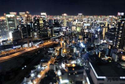 High angle view of illuminated buildings in city at night