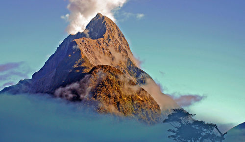 Scenic view of snowcapped mountains against blue sky