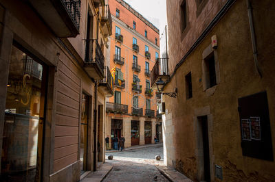 Empty alley amidst buildings in city