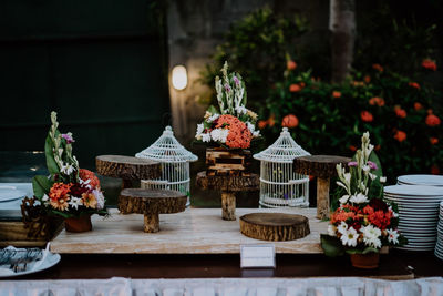 Flower pots on table against wall