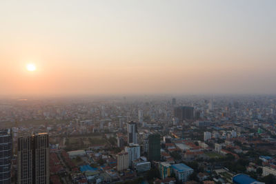 High angle view of modern buildings against sky during sunset