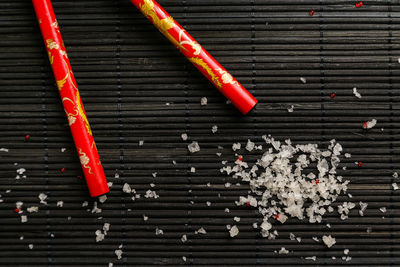 Directly above shot of salt and chopsticks on place mat