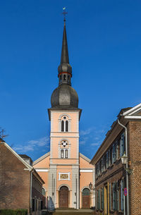 Low angle view of buildings against blue sky