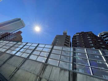 Low angle view of modern building against blue sky