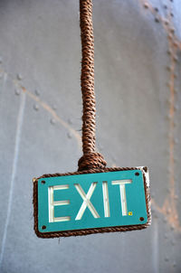 Close-up of exit sign against the wall