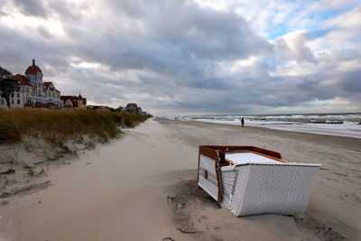 Lifeguard hut on beach by sea against sky