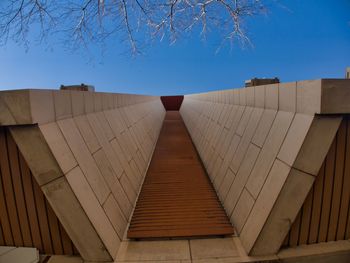 Low angle view of modern building against clear blue sky