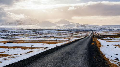 Panoramic view of snowcapped mountain against cloudy sky