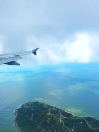 Cropped image of landscape against cloudy sky