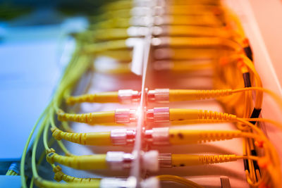 Close-up of yellow cables attached to electrical equipment