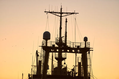 Silhouettes of ships and container cranes in sea port, sunset background. scenery industrial