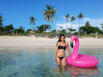 Full length of woman on beach against sky