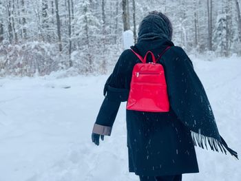 Rear view of senior woman on snow covered land