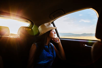 Woman looking at car window