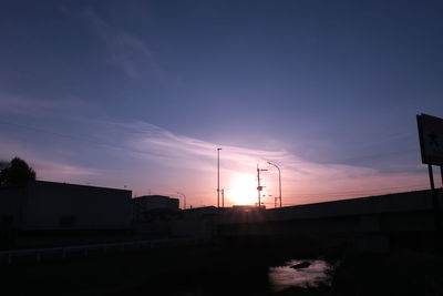 Silhouette of buildings against sky during sunset