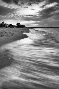 View of beach against cloudy sky