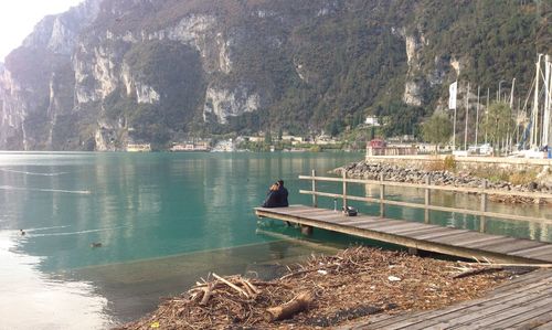 Scenic view of lake by trees against mountain