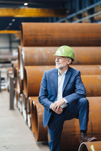 Male professional with hardhat standing in warehouse