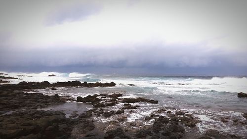 Scenic view of sea against cloudy sky