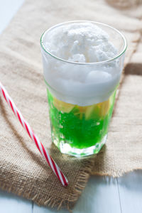 Close-up of ice cream and drink in glass on table