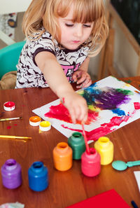 Girl painting with watercolors