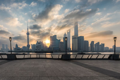 Buildings in city against cloudy sky